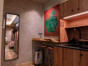 a kitchen with a painting of a pepper on the wall at The Mdina Heritage Boutique Hotel - By Luxury Villas International in Rabat +109 photos