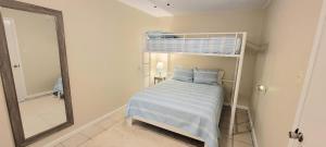 a bedroom with a bunk bed and a mirror at Bay View Great Deck Pool 2 levels & 3 bedr condo in South Padre Island +100 photos