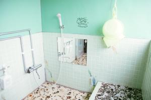 a bathroom with blue tiled walls and a mirror at OMOTENASHI LODGE Yuyu - Vacation STAY 11761 in Nakafurano +75 photos