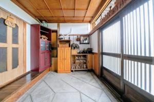 a hallway with a room with a large window at OMOTENASHI LODGE Yuyu - Vacation STAY 11761 in Nakafurano