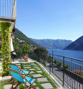 a chair sitting on a balcony overlooking the water at Balcone dei Limoni in Nesso