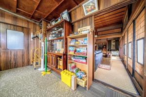 a room with wood paneled walls and a library at OMOTENASHI LODGE Yuyu - Vacation STAY 11761 in Nakafurano
