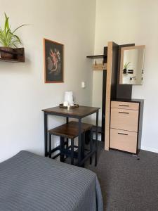 a room with a desk and a mirror and a bed at Studija Mona in Vilnius
