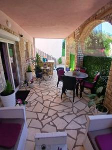 a patio with a table and chairs on a patio at DosPalmeras in Vir