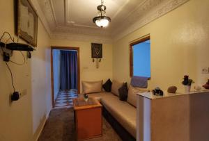 a living room with a couch and a table at Relax House in Ikhorbane