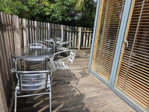 a row of tables and chairs on a patio at South House in Winchester
