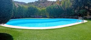 a large pool in a yard with green grass at Villino Tiriddò Porto San Paolo in Porto San Paolo