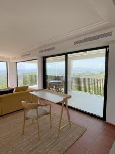 a living room with a table and chairs and windows at Luxury Casa-Saltwater Pool 6x12m in Alginet +51 photos