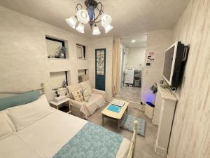 a small living room with a bed and a couch at Eternity APARTMENT HOTEL SHINAGAWA in Tokyo +242 photos