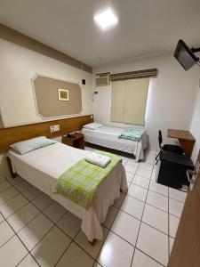 Postel nebo postele na pokoji v ubytování Bravo City Hotel Presidente Prudente