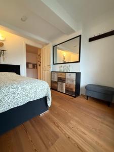 a bedroom with a bed and a large mirror at Mountain Apartment in Fliess +14 photos