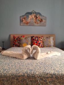 a bed with a heart made out of towels at Profumo di Sicilia Augusta in Augusta