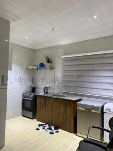 a kitchen with a sink and a stove at PacificAirbnb in Abrekuma