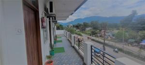 a balcony of a building with a view of a street at Prem Home Stay in Rishīkesh