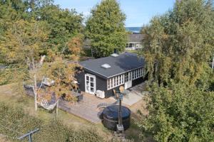an aerial view of a house with a large wooden deck at Charming Cottage Close To The Beach in Glesborg