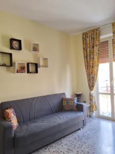 a blue couch in a living room with a window at Profumo di Sicilia Augusta in Augusta