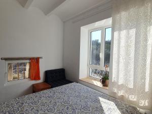 a bedroom with a bed and a window at Molí d'en Salom in Sant Climent Sescebes