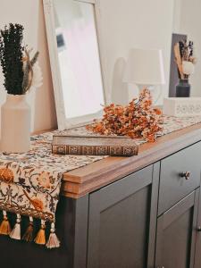 a table with a book on a counter with a mirror at Suite Gonzaga in Messina