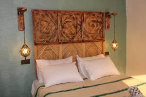 a bedroom with a bed with two white pillows at auberge Brava Tifnit  +65 photos