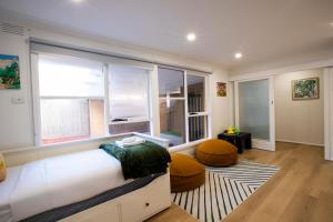 a bedroom with a bed and a large window at Pool, Games & fun - Family Retreat! in Boronia +61 photos