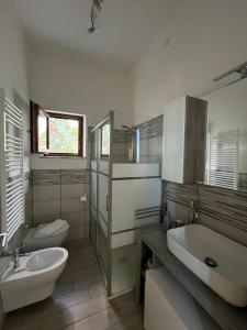 a bathroom with a sink and a toilet and a tub at Nello House in Vico Equense +8 photos