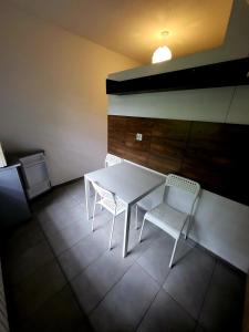 a white table and two chairs in a room at M Hostel in Gliwice +123 photos