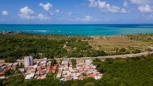 an aerial view of a city and the ocean at Flats Regamar in Porto De Galinhas