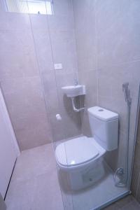 a bathroom with a shower with a toilet and a sink at Flats Regamar in Porto De Galinhas +2 photos