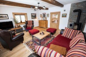 a living room with a couch and a table at Cosy Cottage in Vyšná Boca in Vyšná Boca