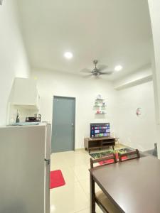 a kitchen with a refrigerator and a table at Mesahill Studio above mall by Zana HOMESTAY in Nilai
