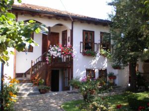 an old house with flowers in the courtyard at Tsutsovi House in Kalofer