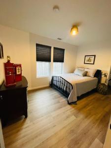a bedroom with a bed and a wooden floor at New Home! Hilltop Hideaway near Historic Dahlonega in Dahlonega