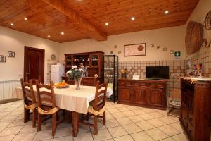 a kitchen with a table with a vase of flowers on it at B&B Le Tre rose dell'Etna in Zafferana Etnea