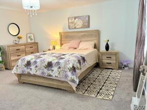 a bedroom with a large bed and two night stands at 210 Bertrand St in Winnipeg