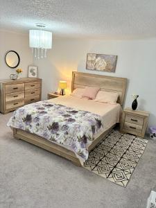 a bedroom with a large bed and two night stands at Tamira Villa in Winnipeg