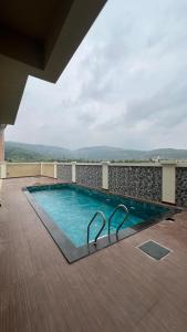a swimming pool on the roof of a building at Royal Elite - 6BHK Luxury Villa by Royal Villa Lonavla in Lonavala