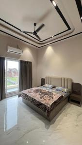 a bedroom with a bed and a large window at Royal Elite - 6BHK Luxury Villa by Royal Villa Lonavla in Lonavala