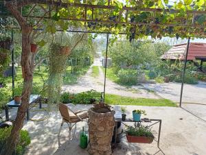 a garden with a table and chairs and a tree at Green Valley GV in Kotor +11 photos