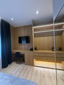 a hotel room with a desk and a television at 4 Rooms Tirana in Tirana