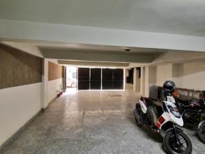 a garage with two motorcycles parked in it at Hotel O Darshan Palace in New Delhi