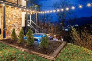a house with lights on the side of it at Ober Lux Chalet in Gatlinburg