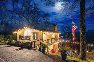 a house decorated with christmas lights at night at Ober Lux Chalet in Gatlinburg