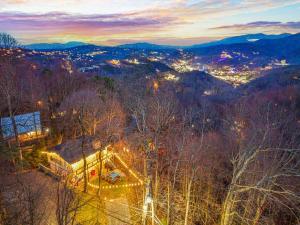 an aerial view of a city at night with lights at Ober Lux Chalet in Gatlinburg +56 photos
