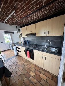 a kitchen with a sink and a stove top oven at Studio 94 in Welkenraedt