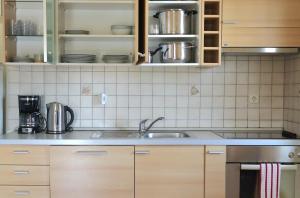 a kitchen with a sink and a counter top at Apartmani California in Starigrad-Paklenica