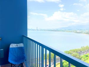 a blue balcony with a view of the water at Bay Suites海景市中心 宽敞 悬空泳池 随订随住-19 in Kota Kinabalu