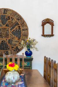 a table with a vase of flowers on top of it at Lake Pichola Hibiscus Hotel in Udaipur