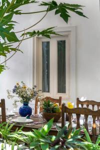 a dining room table with a blue vase on it at Lake Pichola Hibiscus Hotel in Udaipur
