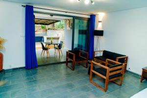 a living room with a chair and a table at Cattleya Guest house in Hell-Ville