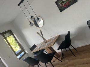 a dining room with a wooden table and chairs at A&A Mosel in Bernkastel-Kues